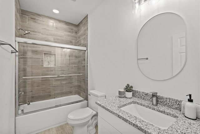 full bathroom featuring toilet, vanity, and enclosed tub / shower combo