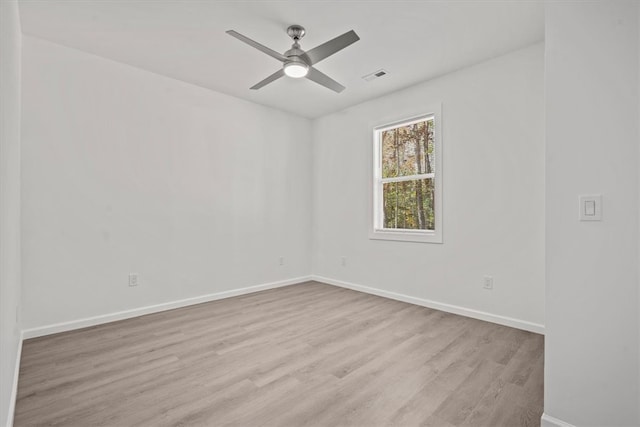 empty room with ceiling fan and light hardwood / wood-style flooring