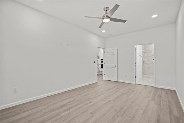 unfurnished bedroom featuring ceiling fan, connected bathroom, and light wood-type flooring