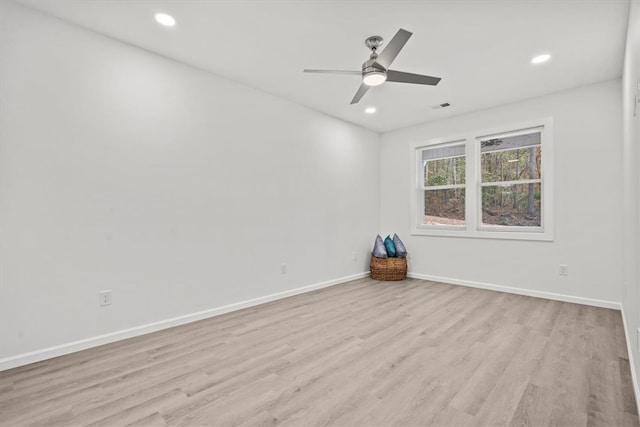 spare room featuring light wood-type flooring and ceiling fan