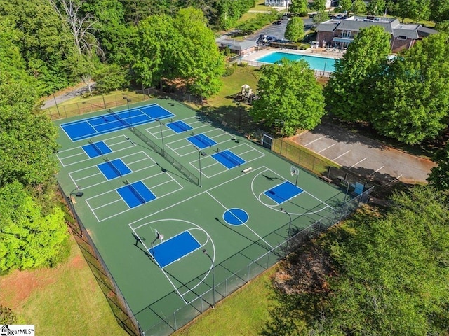 view of sport court featuring a community pool and tennis court