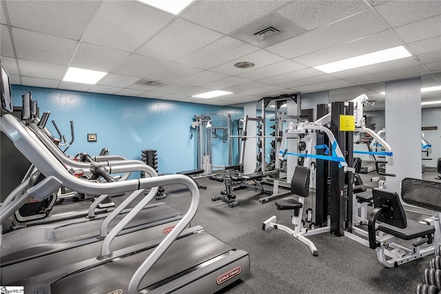 exercise room with a paneled ceiling