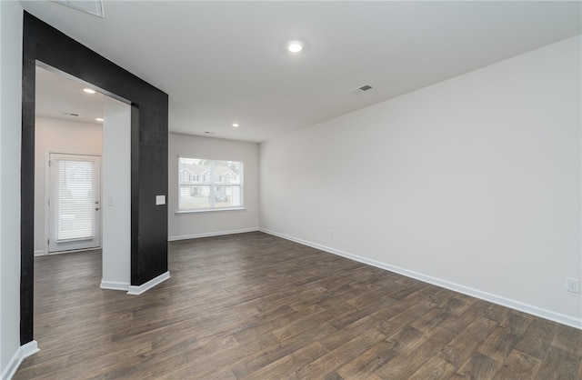 unfurnished room featuring dark wood-type flooring