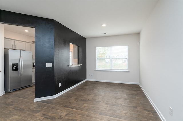 spare room featuring dark wood-type flooring