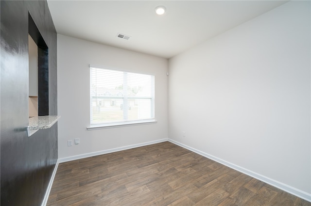 empty room with dark hardwood / wood-style floors