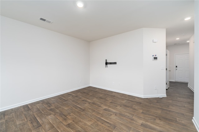 empty room with dark hardwood / wood-style floors