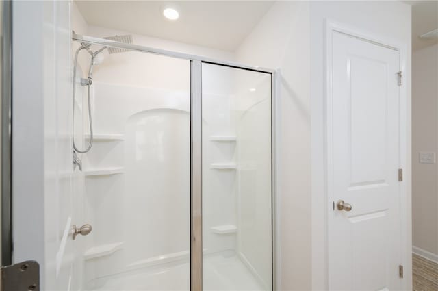 bathroom featuring a shower with shower door