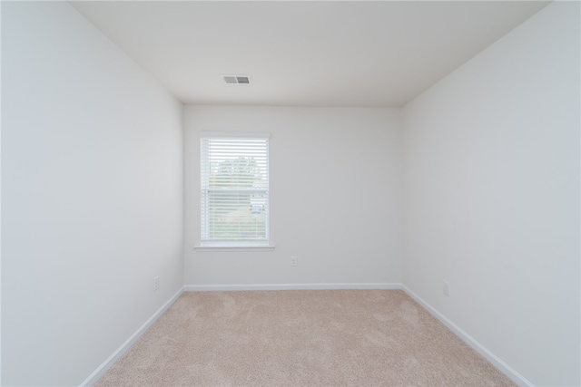 spare room with light carpet