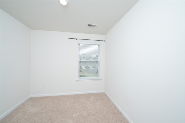 unfurnished room featuring light carpet