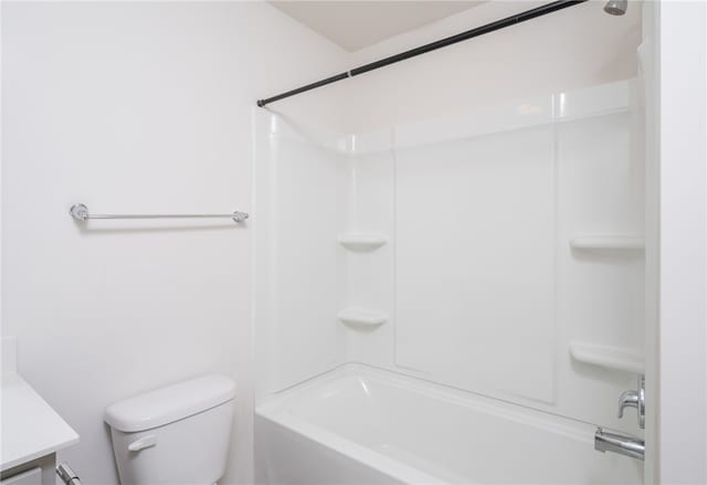 full bathroom featuring toilet, washtub / shower combination, and vanity