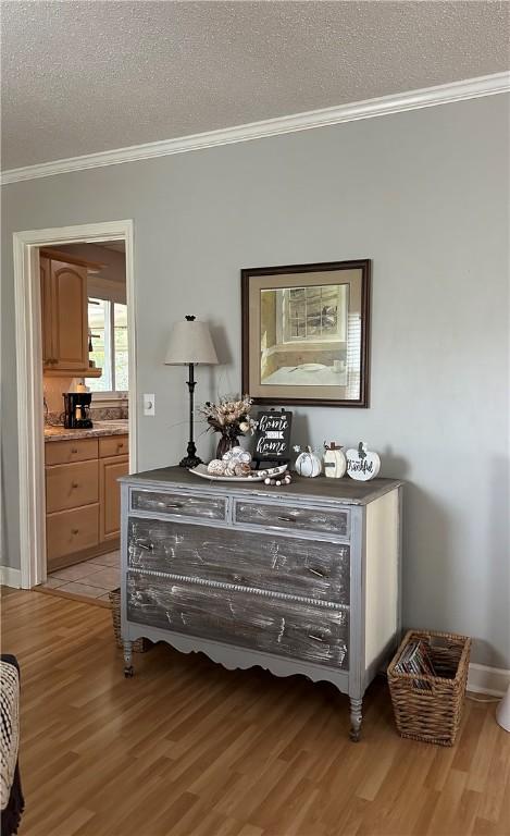 room details with hardwood / wood-style floors, ornamental molding, and a textured ceiling