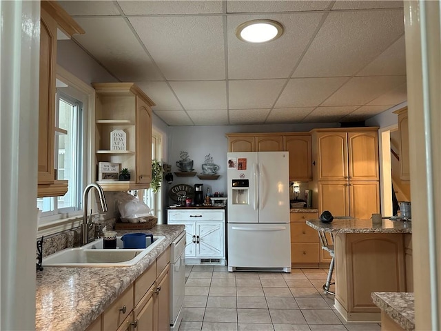 kitchen featuring plenty of natural light, light tile patterned flooring, white appliances, and sink