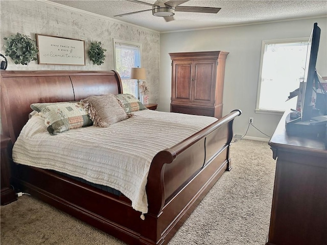 carpeted bedroom with a textured ceiling, ceiling fan, and crown molding