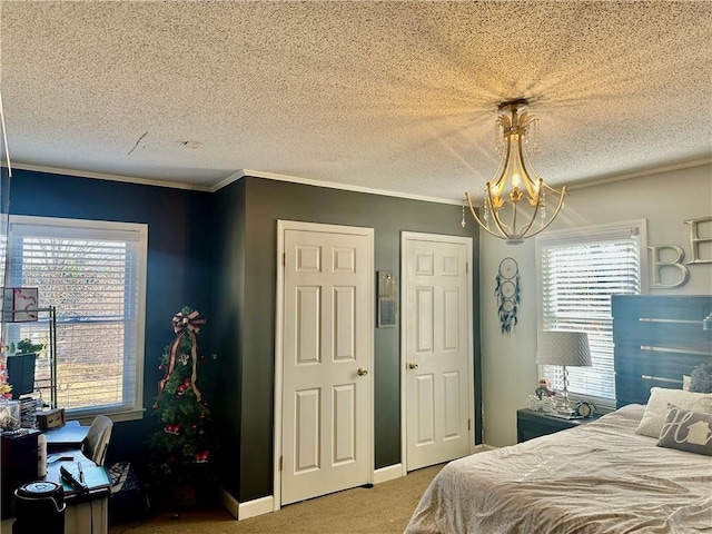 bedroom with carpet flooring, an inviting chandelier, a textured ceiling, and multiple windows