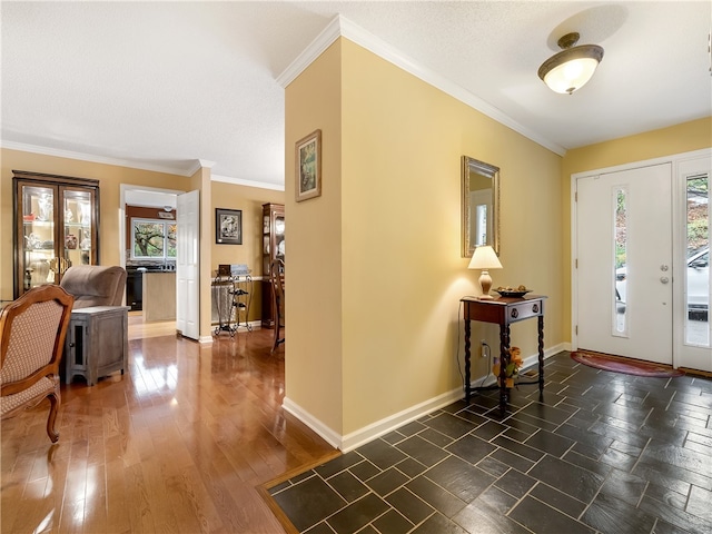 entrance foyer featuring a wealth of natural light, a textured ceiling, dark hardwood / wood-style floors, and crown molding