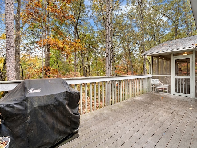 deck with a sunroom and a grill