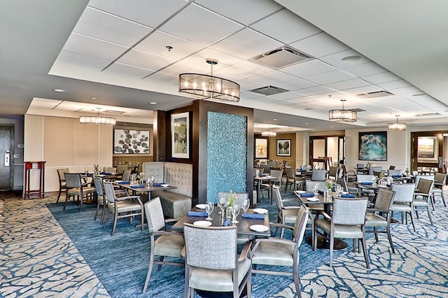 dining room featuring carpet flooring and a paneled ceiling