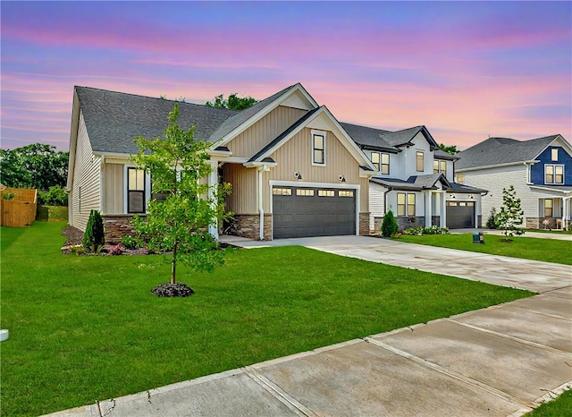 view of front of property featuring a garage and a lawn