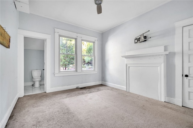 interior space featuring ceiling fan, crown molding, and carpet floors