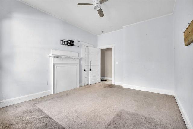 spare room featuring ornamental molding, carpet, and ceiling fan