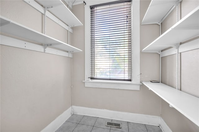 walk in closet featuring light tile patterned floors