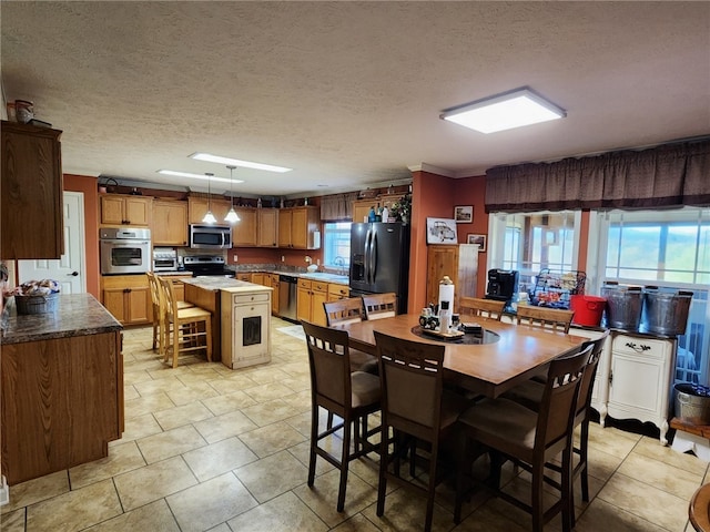 dining space with a textured ceiling and sink