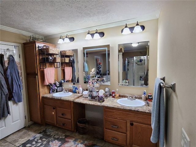 bathroom featuring walk in shower, vanity, a textured ceiling, and ornamental molding