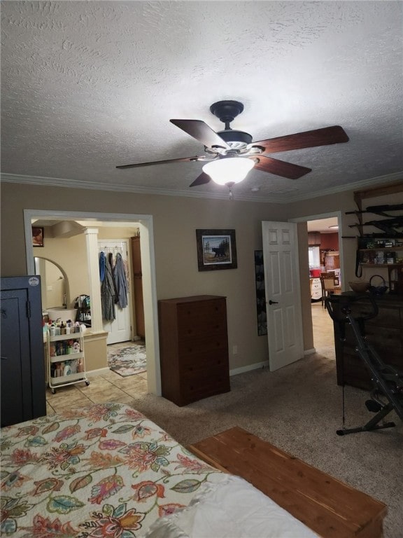 carpeted bedroom featuring ceiling fan, a textured ceiling, a closet, and crown molding