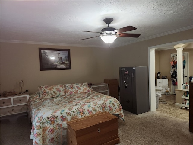 bedroom with ensuite bath, ceiling fan, a textured ceiling, crown molding, and light colored carpet