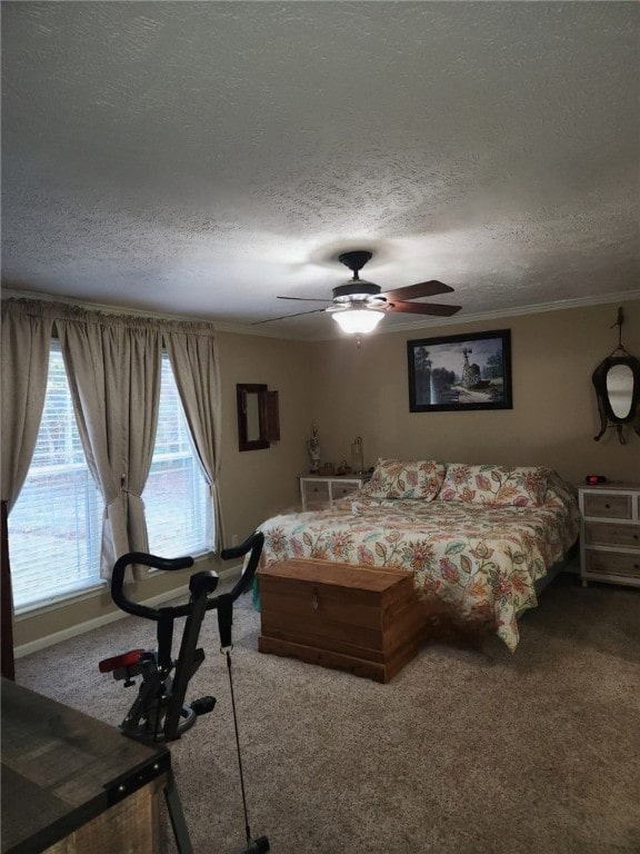 carpeted bedroom with a textured ceiling, ceiling fan, and crown molding