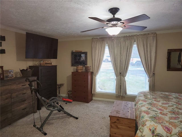 carpeted bedroom with a textured ceiling, ceiling fan, and crown molding