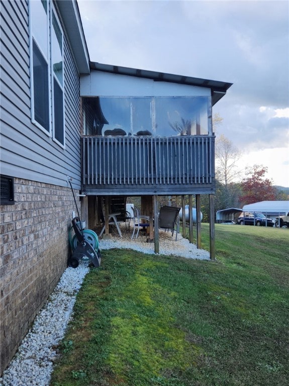 back of property with a lawn and a wooden deck