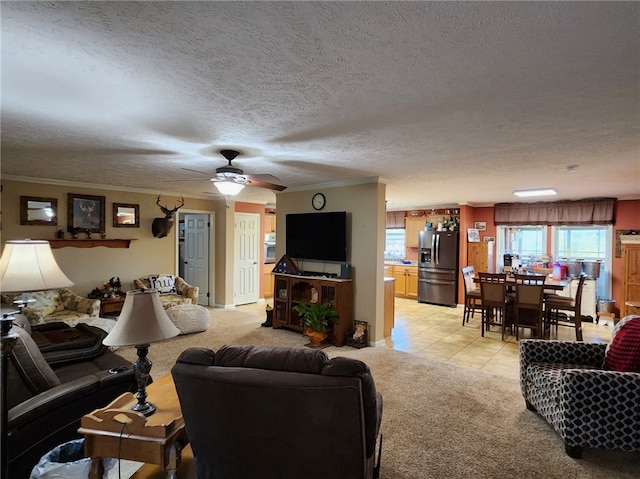 living room featuring ornamental molding, a textured ceiling, ceiling fan, and light tile patterned floors