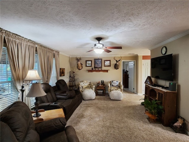 living room featuring ceiling fan, a textured ceiling, carpet floors, and ornamental molding