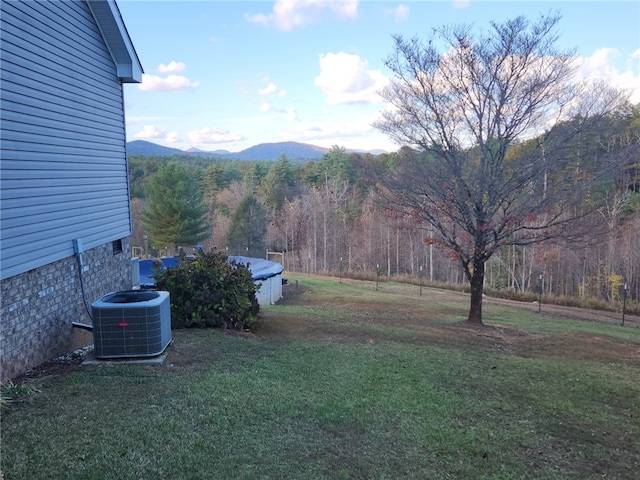 view of yard with cooling unit and a mountain view