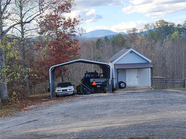 garage with a carport and a mountain view