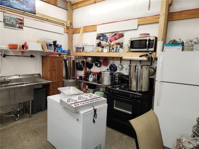 kitchen featuring black range and white refrigerator