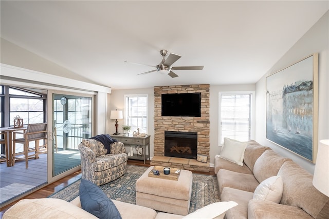 living room with hardwood / wood-style floors, a fireplace, lofted ceiling, and ceiling fan