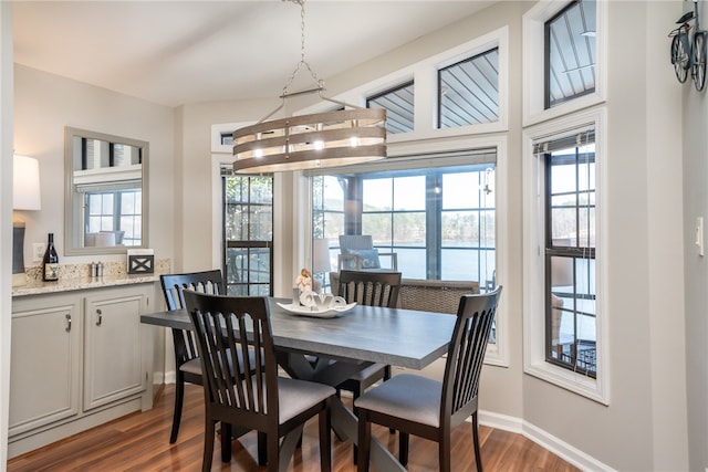 dining room featuring dark hardwood / wood-style flooring and a notable chandelier