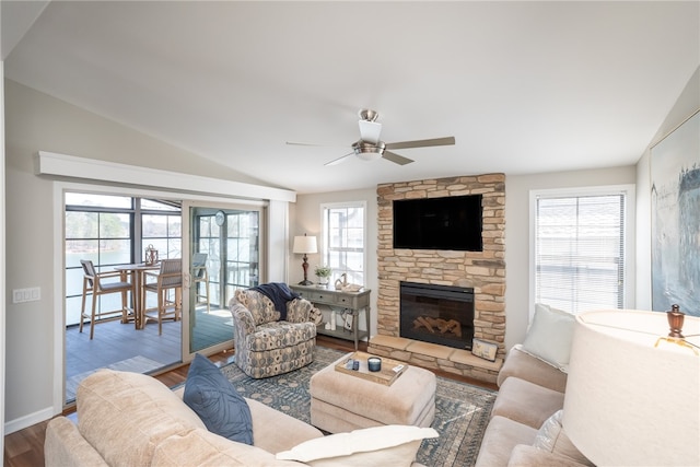 living room featuring hardwood / wood-style floors, vaulted ceiling, ceiling fan, and plenty of natural light