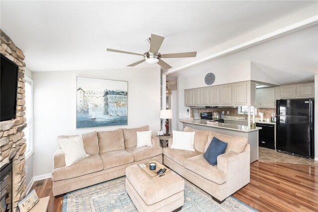 1230 Melton Rd Unit 31, West Union, SC 29696 - living room with light wood finished floors, a ceiling fan, a stone fireplace, and vaulted ceiling