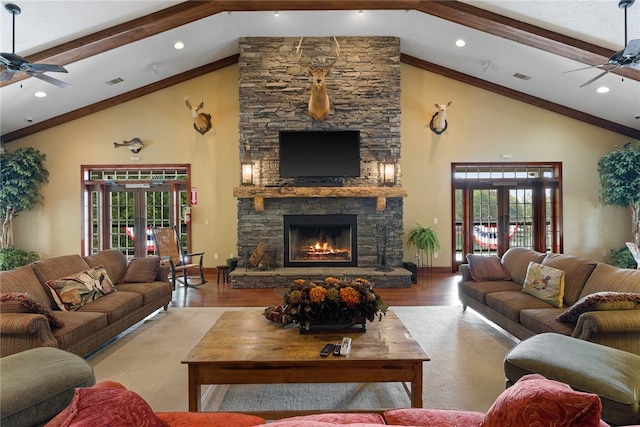 living room with french doors, a fireplace, light hardwood / wood-style flooring, and beam ceiling