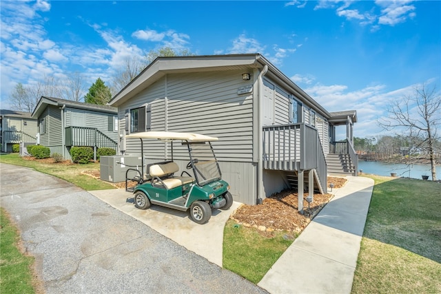 view of property exterior with a yard and a deck