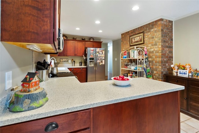 kitchen featuring stainless steel fridge, light stone countertops, kitchen peninsula, and crown molding