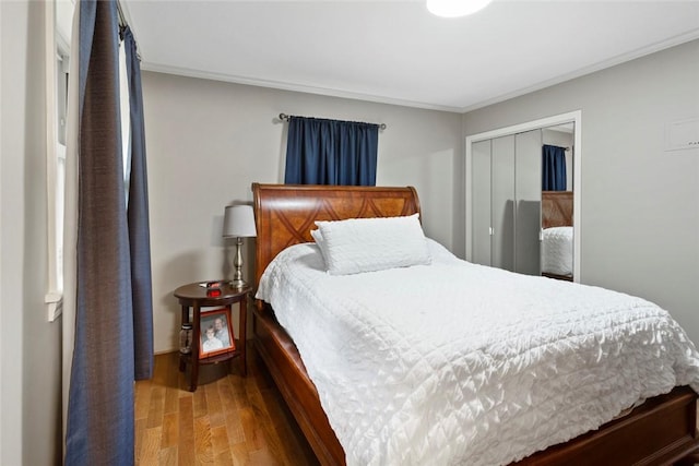 bedroom featuring hardwood / wood-style floors, a closet, and ornamental molding