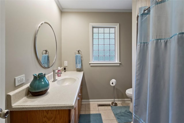 bathroom featuring tile patterned floors, crown molding, vanity, and toilet