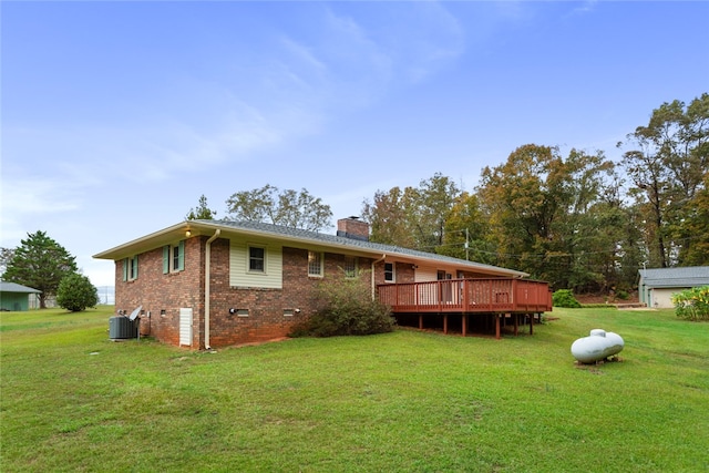 back of house with a yard, cooling unit, and a wooden deck