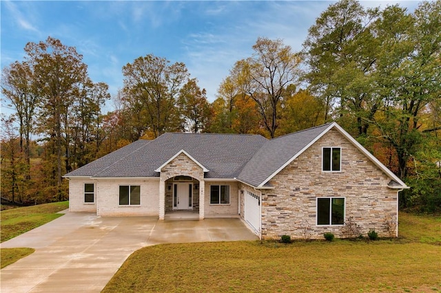 view of front of home with a porch, a front yard, and a garage