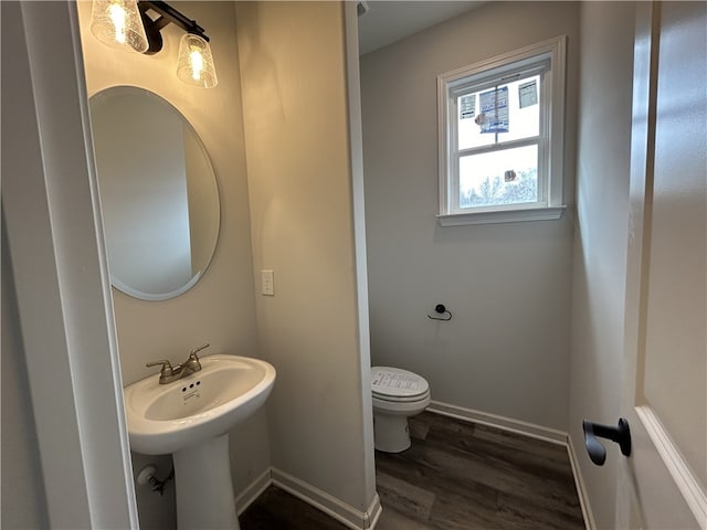 bathroom featuring hardwood / wood-style floors and toilet