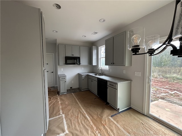 kitchen with gray cabinets, black appliances, sink, and light wood-type flooring